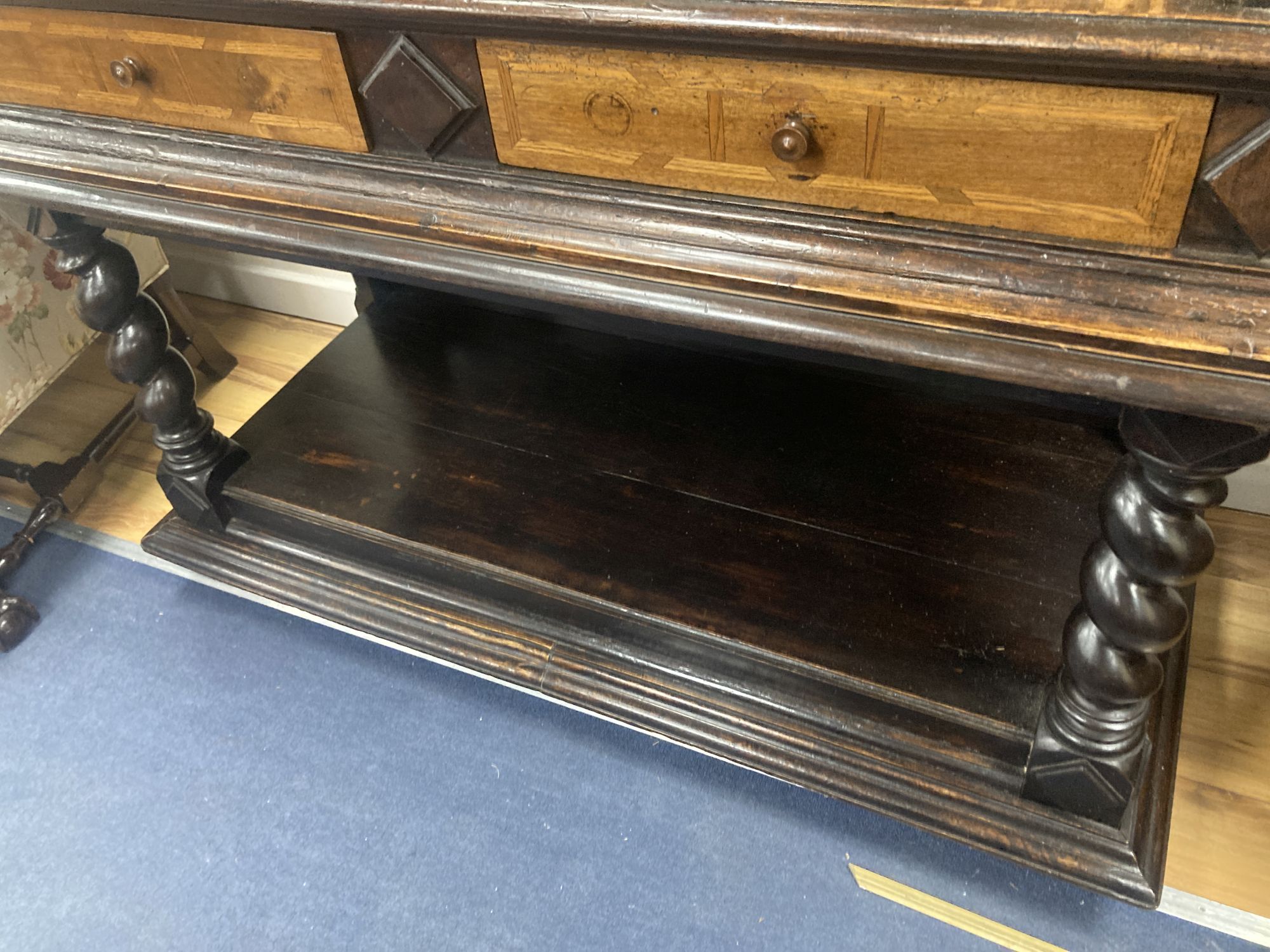 An early 19th century Dutch ebonised parquetry inlaid walnut cabinet on stand, width 136cm, depth 60cm, height 171cm